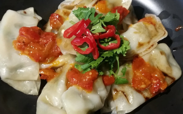 Prawn Gyoza drizzled with Chilli Jam and Black vinegar
