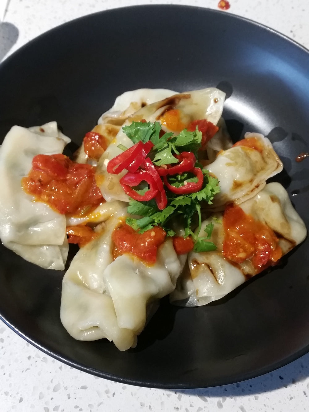 Prawn Gyoza drizzled with Chilli Jam and Black vinegar